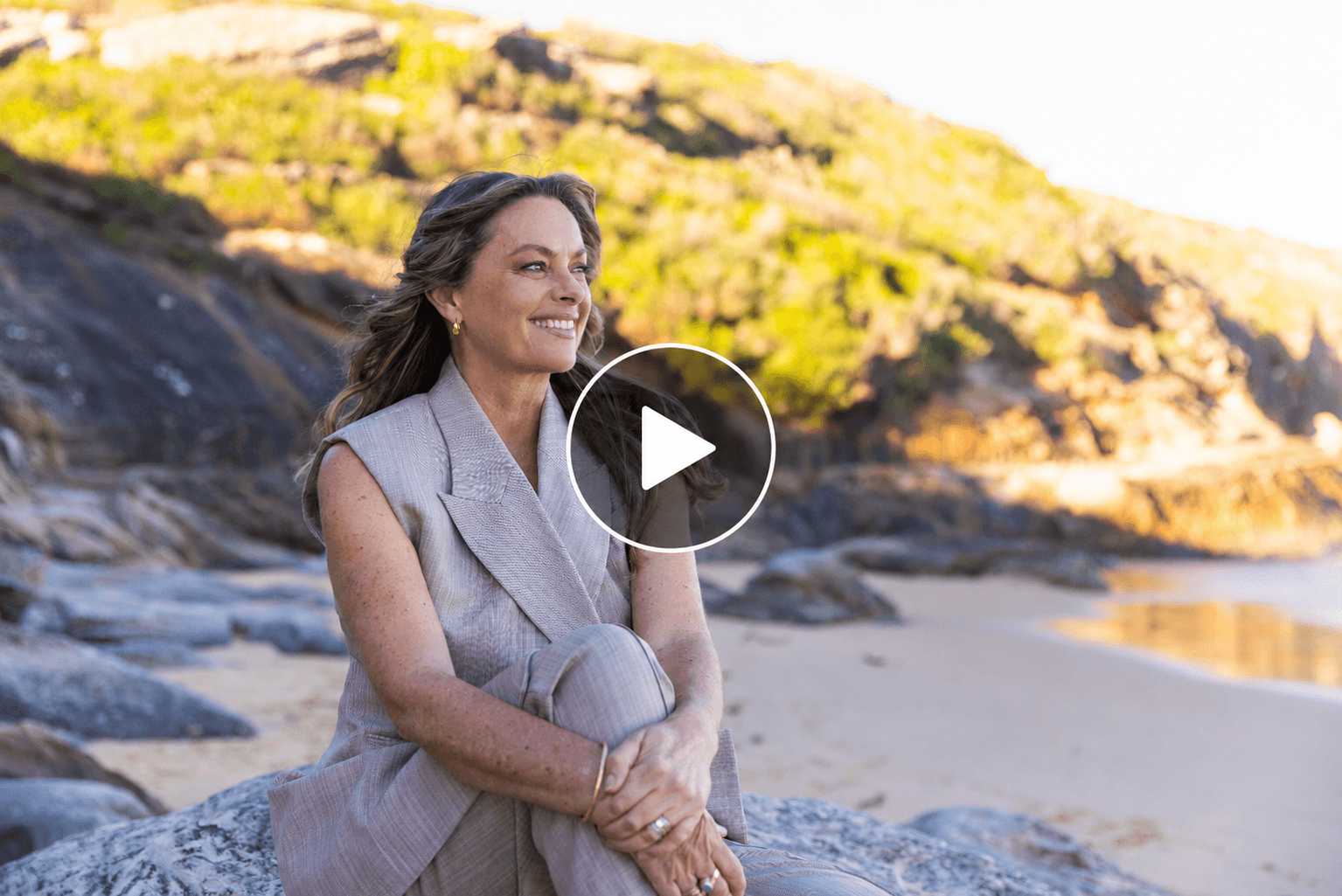 Beach scene with centered play button